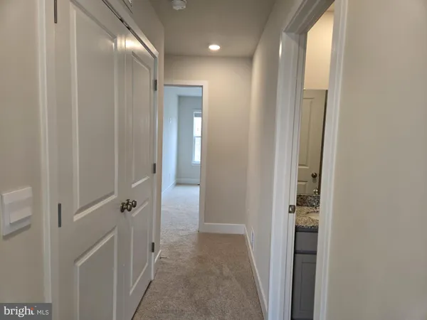 a view of a hallway with wooden shelves