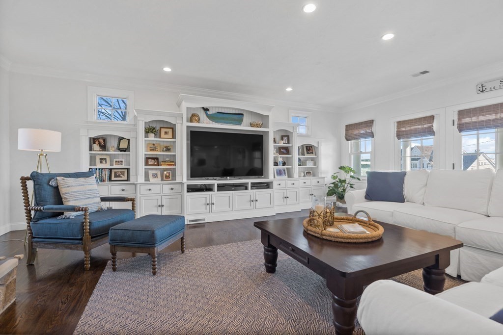 48 Collier Road Scituate, MA 02066 - Photo 22 of 42 a living room with furniture kitchen view and a flat screen tv