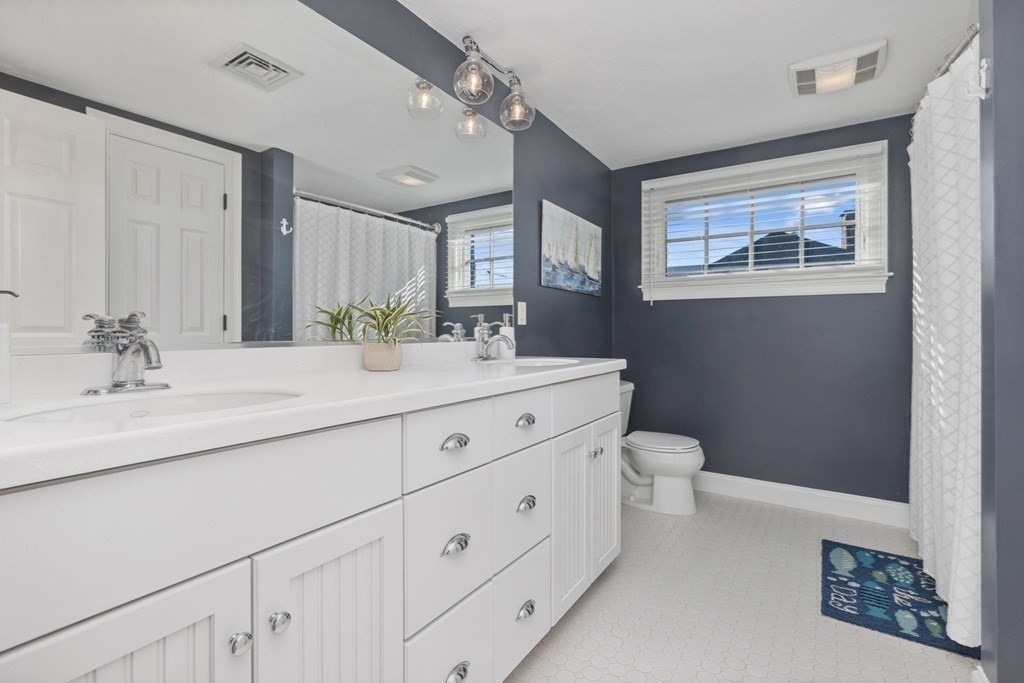 48 Collier Road Scituate, MA 02066 - Photo 27 of 42 a bathroom with a double vanity sink and a mirror