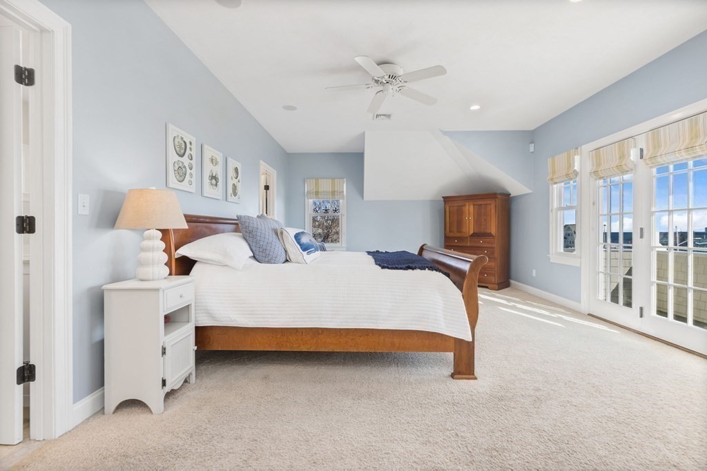 48 Collier Road Scituate, MA 02066 - Photo 32 of 42 a bedroom with a bed and a chandelier