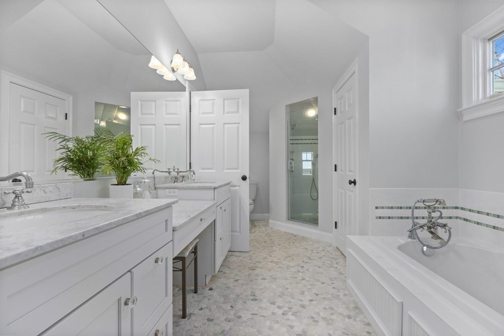 48 Collier Road Scituate, MA 02066 - Photo 33 of 42 a spacious bathroom with a granite countertop sink a large mirror and a bathtub
