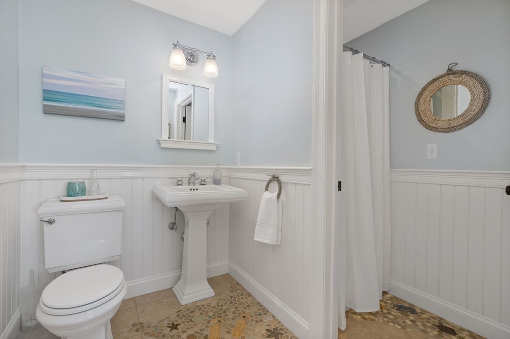 48 Collier Road Scituate, MA 02066 - Photo 10 of 42 a bathroom with a sink a toilet and a mirror