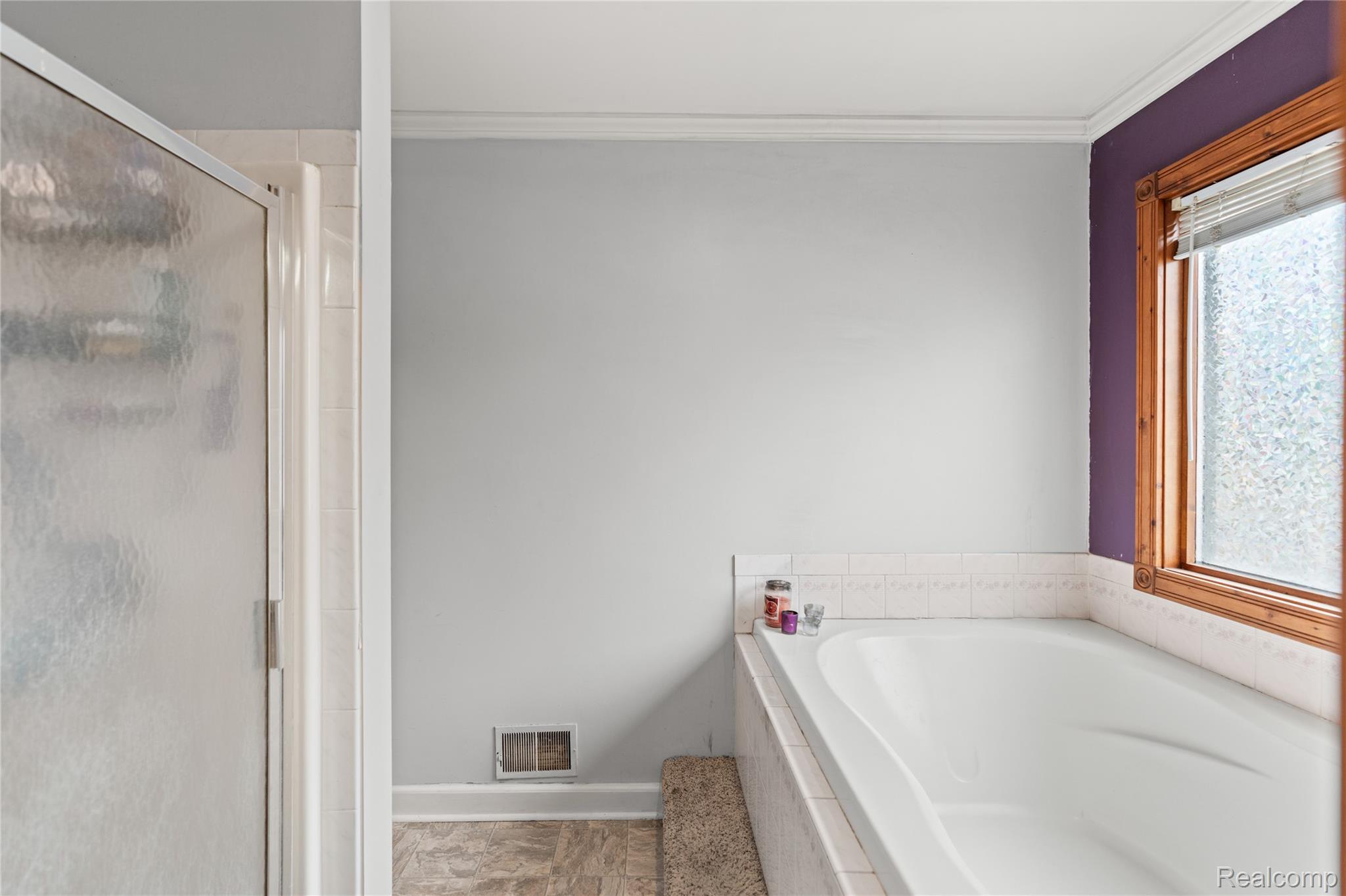 6076 East Carpenter Road Flint, MI 48506 - Photo 27 of 67 Bathroom with crown molding, a garden tub, and a stall shower