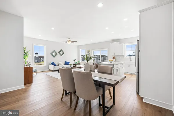 a dining room with furniture and wooden floor