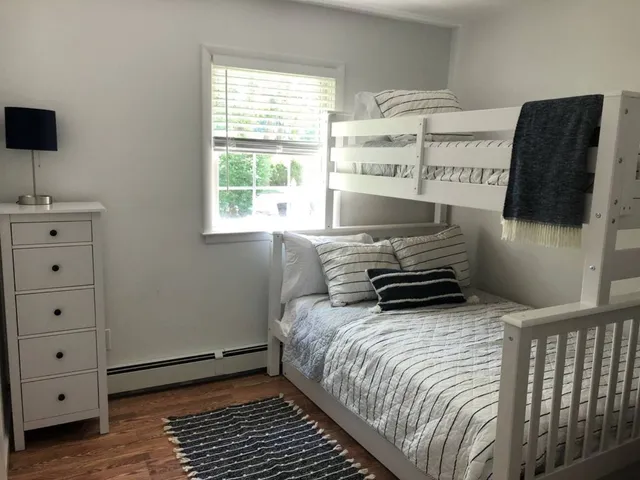 a bedroom with a bed and a window