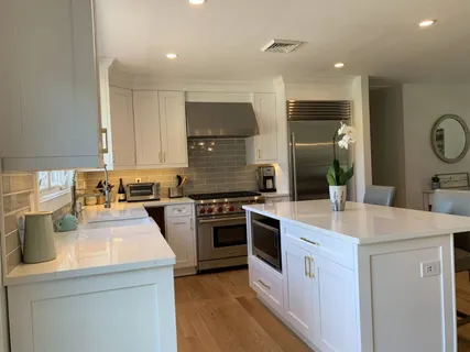 a kitchen with a sink a stove a refrigerator and a stove