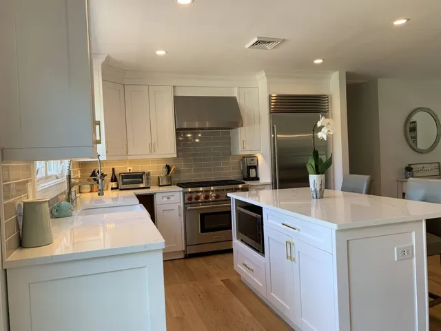 a kitchen with a sink a stove a refrigerator and a stove