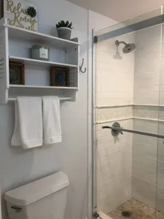 a bathroom with a toilet a sink and shower
