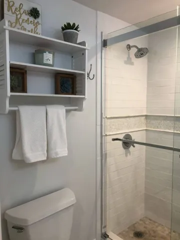 a bathroom with a toilet a sink and shower