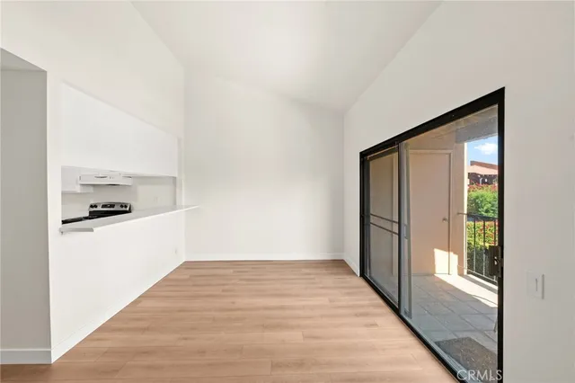 a view of a hallway with wooden floor and a living room