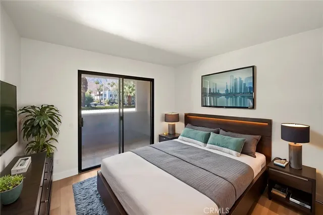 a bedroom with a bed and a potted plant