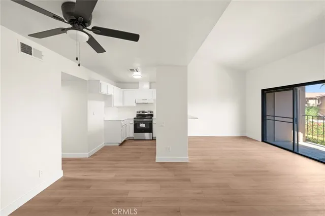 a view of a kitchen with a sink and a refrigerator