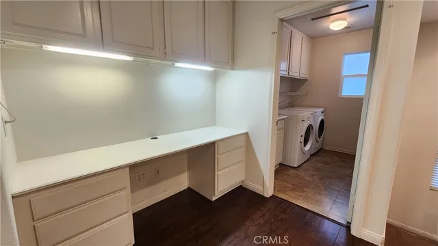 a utility room with cabinets washer and dryer