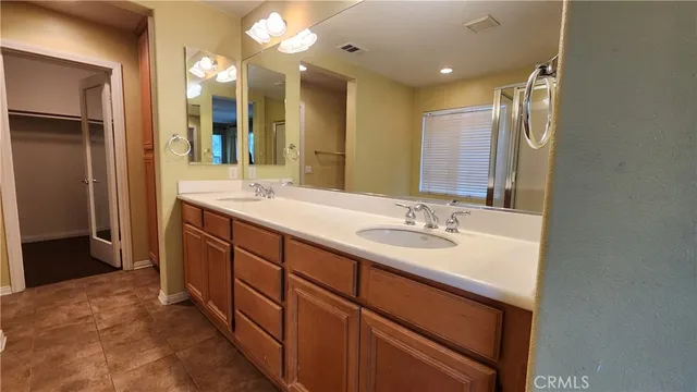 a bathroom with a double vanity sink and a mirror