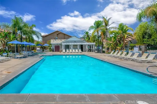a view of a yard with table and chairs under an umbrella