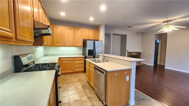 a kitchen that has a sink and a stove in it