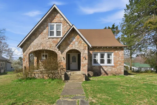 a front view of a house with a garden
