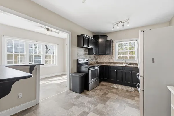 a kitchen with a refrigerator sink and stove