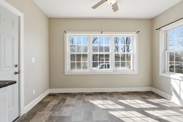 a view of a livingroom with wooden floor and a flat screen tv