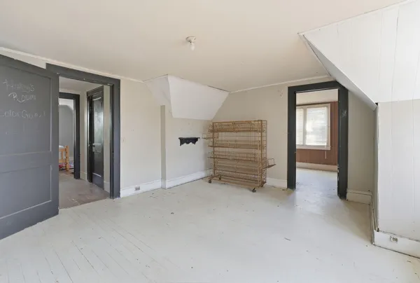 a view of a hallway with wooden floor and entryway