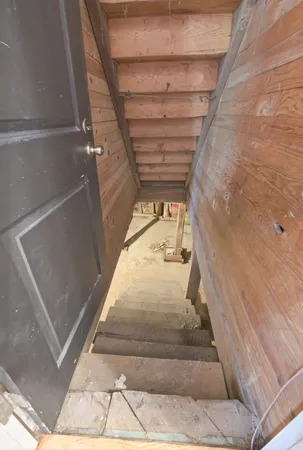 a front view of a house with a garden and trees