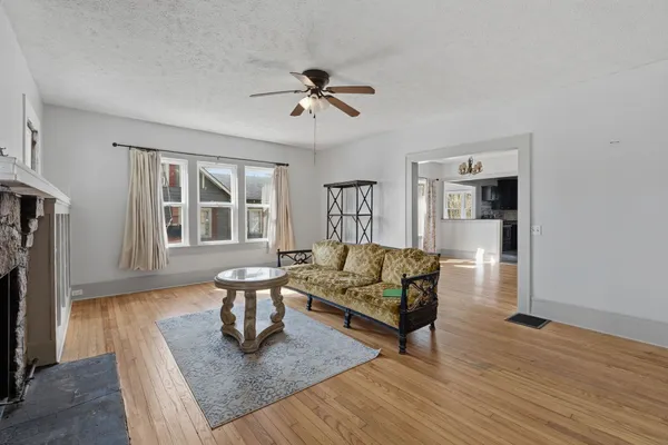 a living room with furniture fireplace and a window