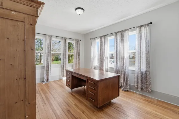 a view of kitchen with furniture and wooden floor