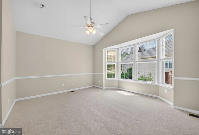 an empty room with a empty space and windows