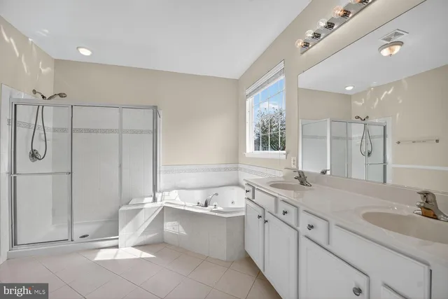 a bathroom with a granite countertop sink mirror and a bathtub
