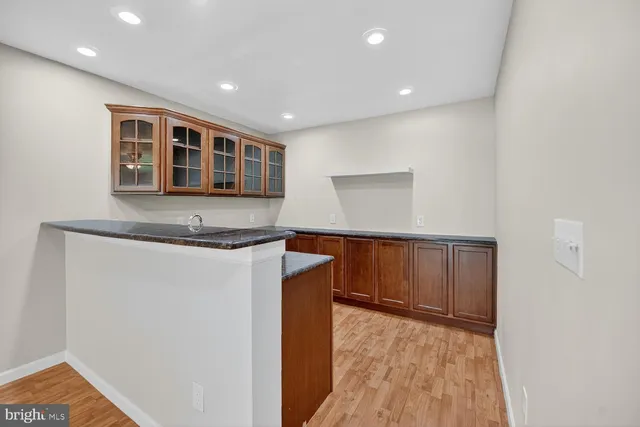 a kitchen with stainless steel appliances granite countertop a sink and wooden cabinets
