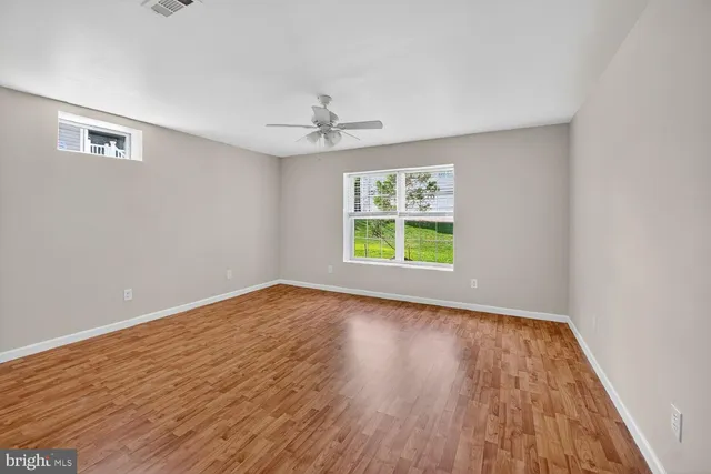 wooden floor in an empty room with a window