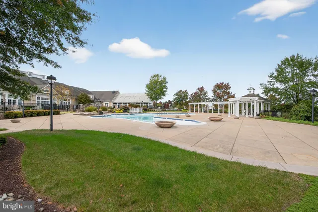a view of yard with swimming pool and green space
