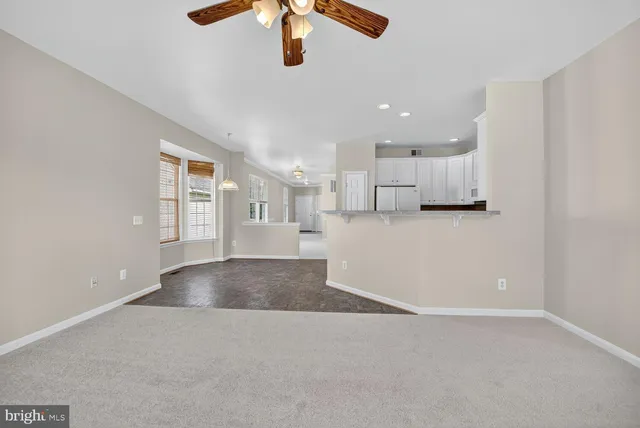 a view of a kitchen with a sink and chandelier fan