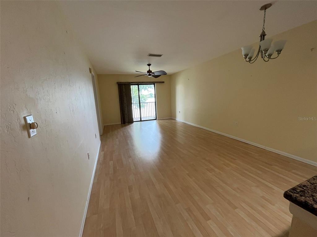 25225 Rampart Boulevard, Unit 2107 Punta Gorda, FL 33983 - Photo 3 of 10 wooden floor in an empty room with a window