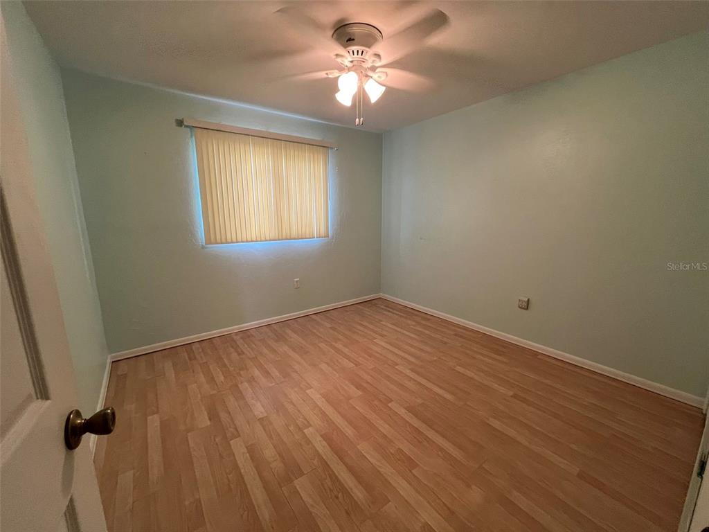 25225 Rampart Boulevard, Unit 2107 Punta Gorda, FL 33983 - Photo 6 of 10 wooden floor in an empty room with a window