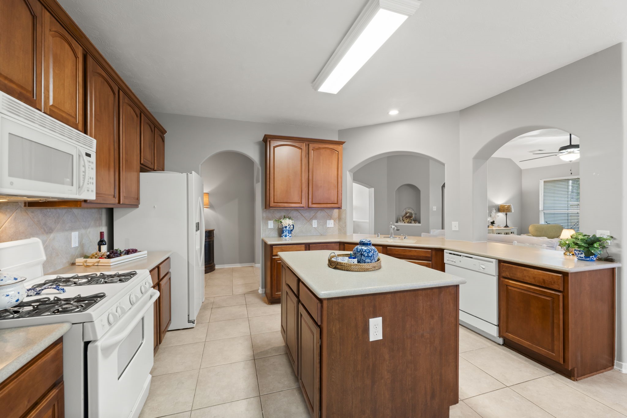 8407 Oak Villa Court Spring, TX 77389 - Photo 13 of 40 a kitchen with a stove a sink dishwasher and a stove with wooden cabinets