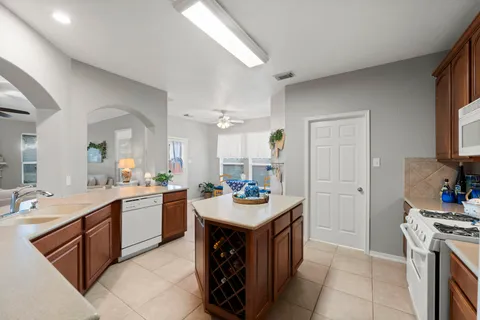 a kitchen with a sink stove and cabinets