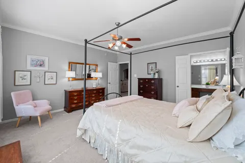 a spacious bedroom with a bed and a view of living room