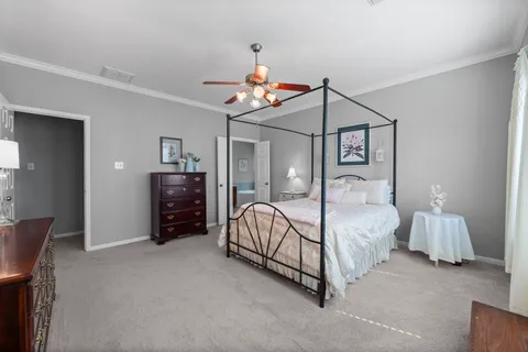 a bedroom with bed and a chandelier