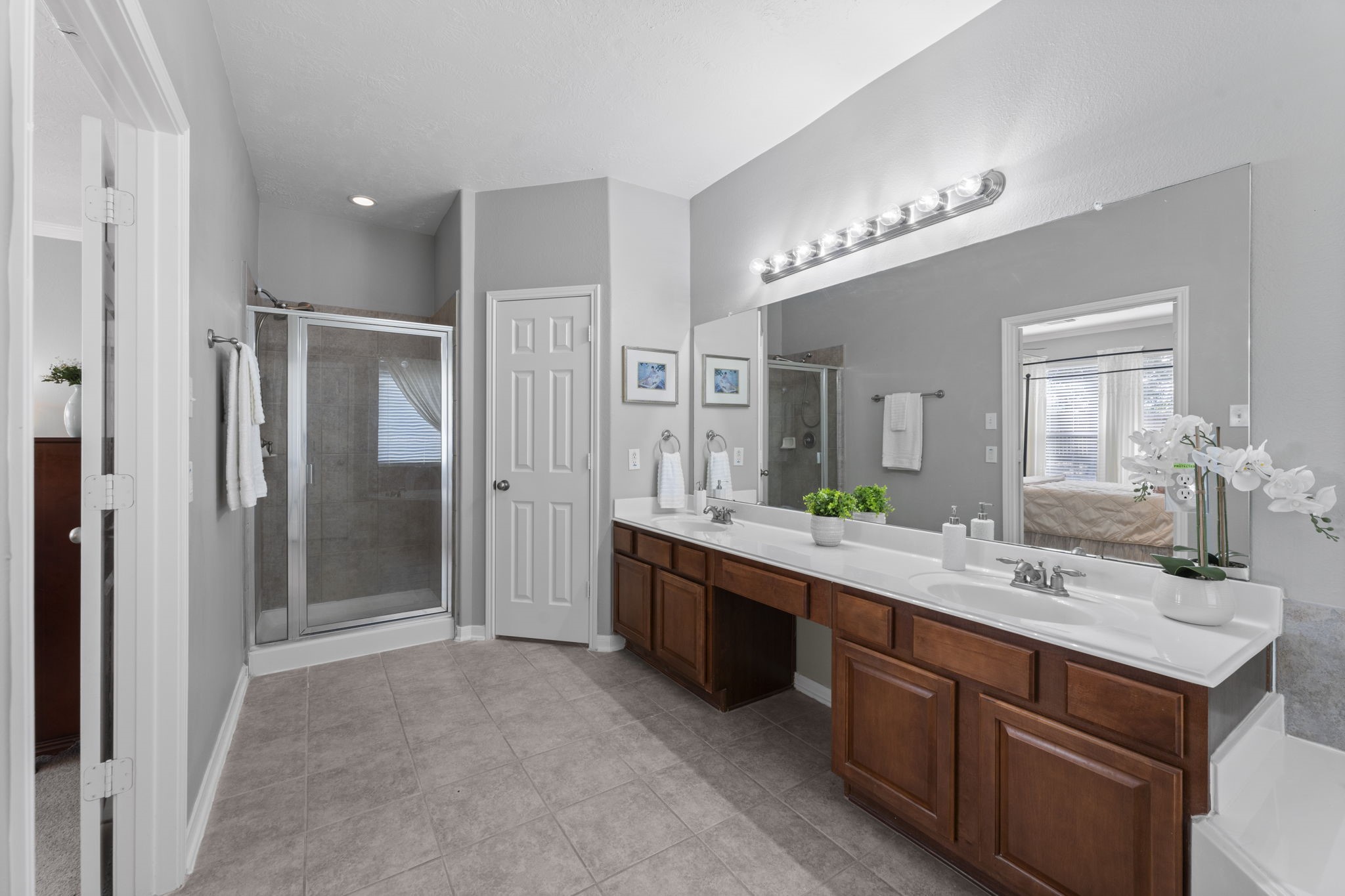 8407 Oak Villa Court Spring, TX 77389 - Photo 27 of 40 a spacious bathroom with a granite countertop sink mirror and shower