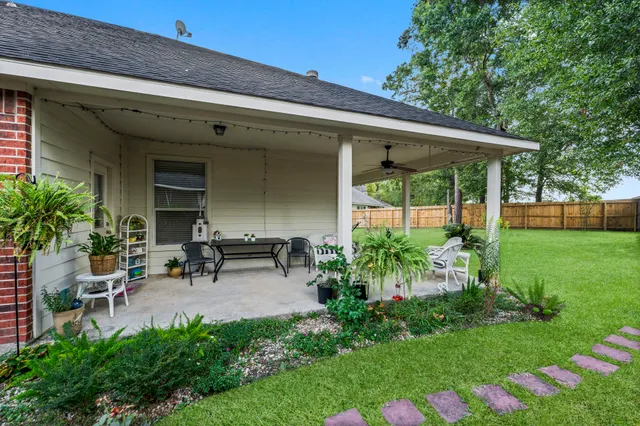 a view of a chair and table in backyard of the house