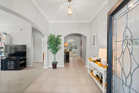 a view of living room filled with furniture and flat screen tv
