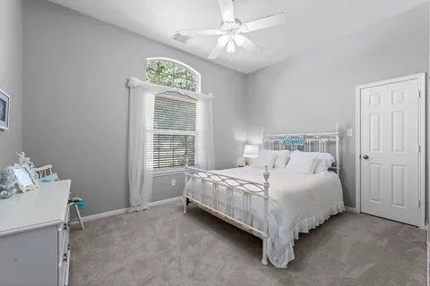 a bed sitting in a bedroom next to a window