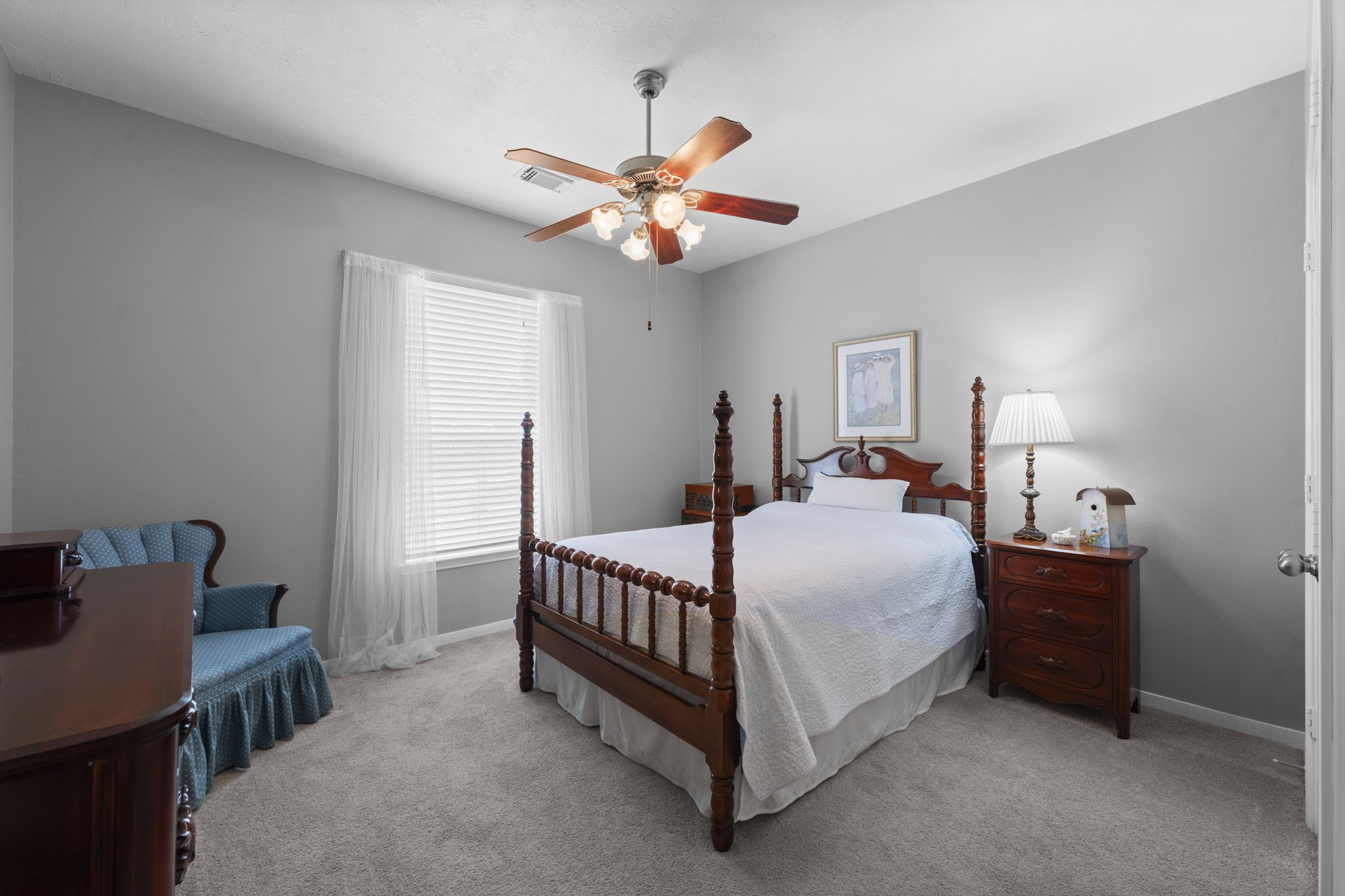 8407 Oak Villa Court Spring, TX 77389 - Photo 10 of 40 a bedroom with a bed and a chandelier