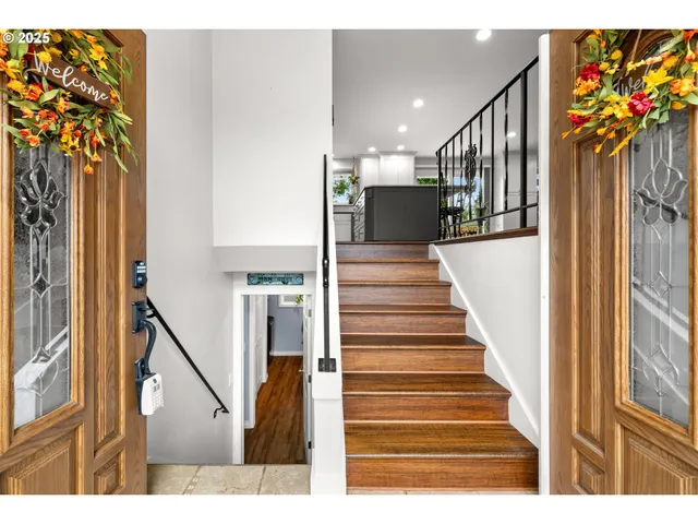 a view of entryway and hall with wooden floor