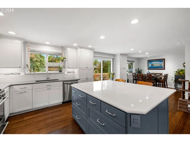 a kitchen with kitchen island a sink table and chairs