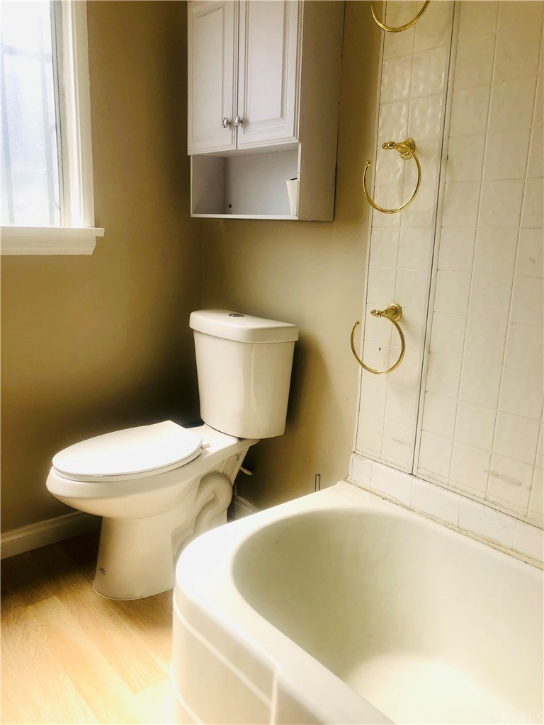 406 West Elm Street Compton, CA 90220 - Photo 11 of 16 a bathroom with a toilet and a sink