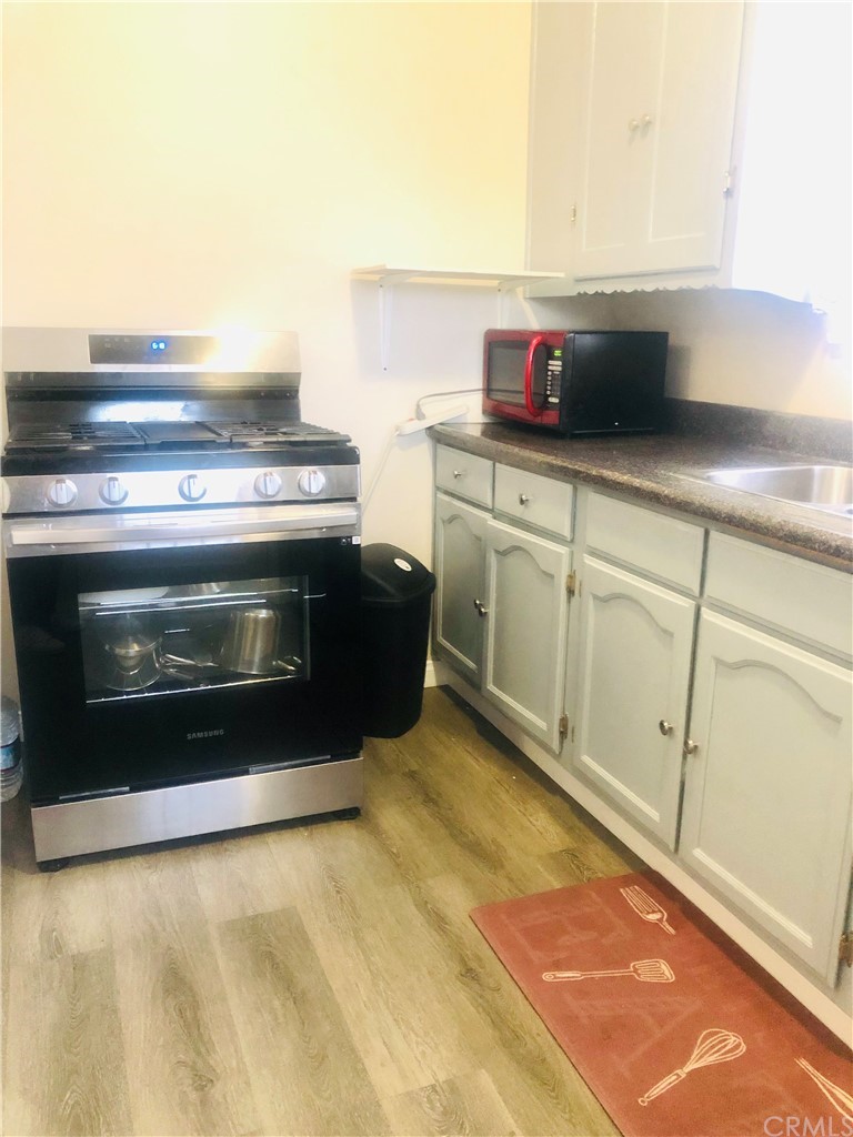 406 West Elm Street Compton, CA 90220 - Photo 7 of 16 a kitchen with a stove and a microwave