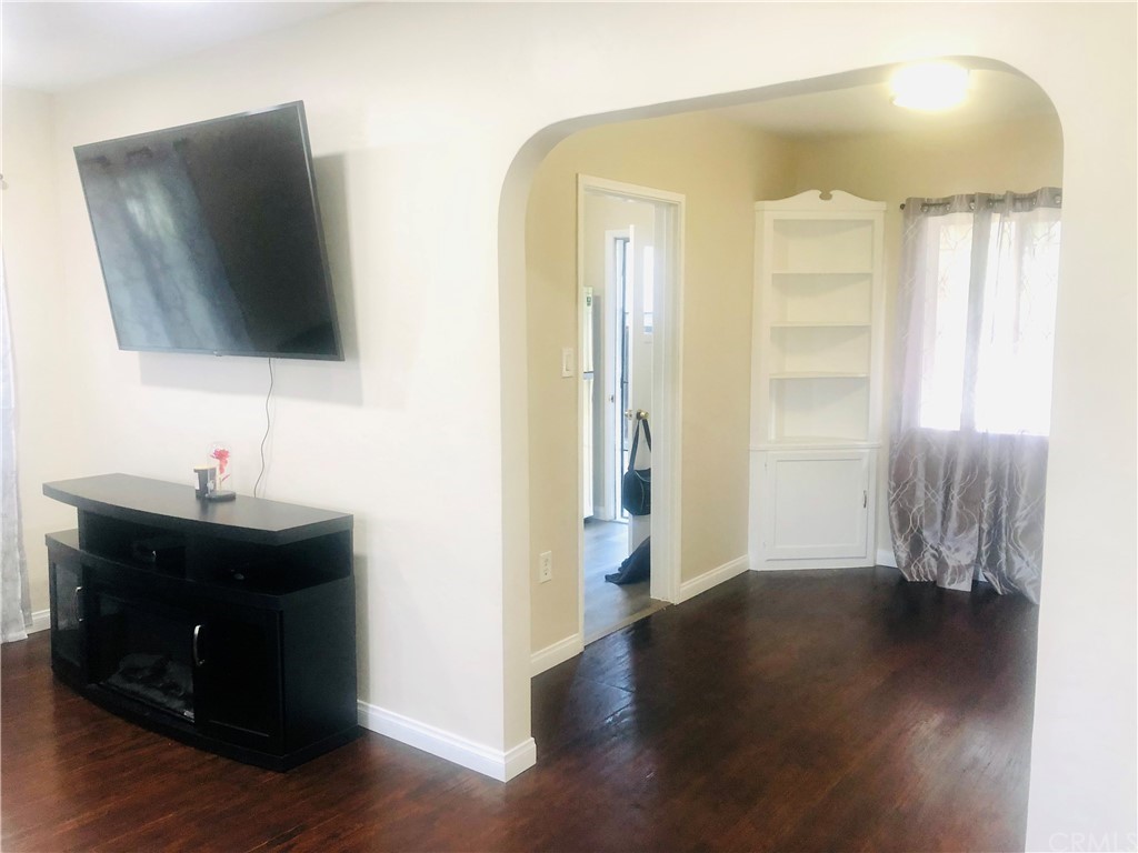 406 West Elm Street Compton, CA 90220 - Photo 9 of 16 a view of a livingroom with wooden floor and a flat screen tv