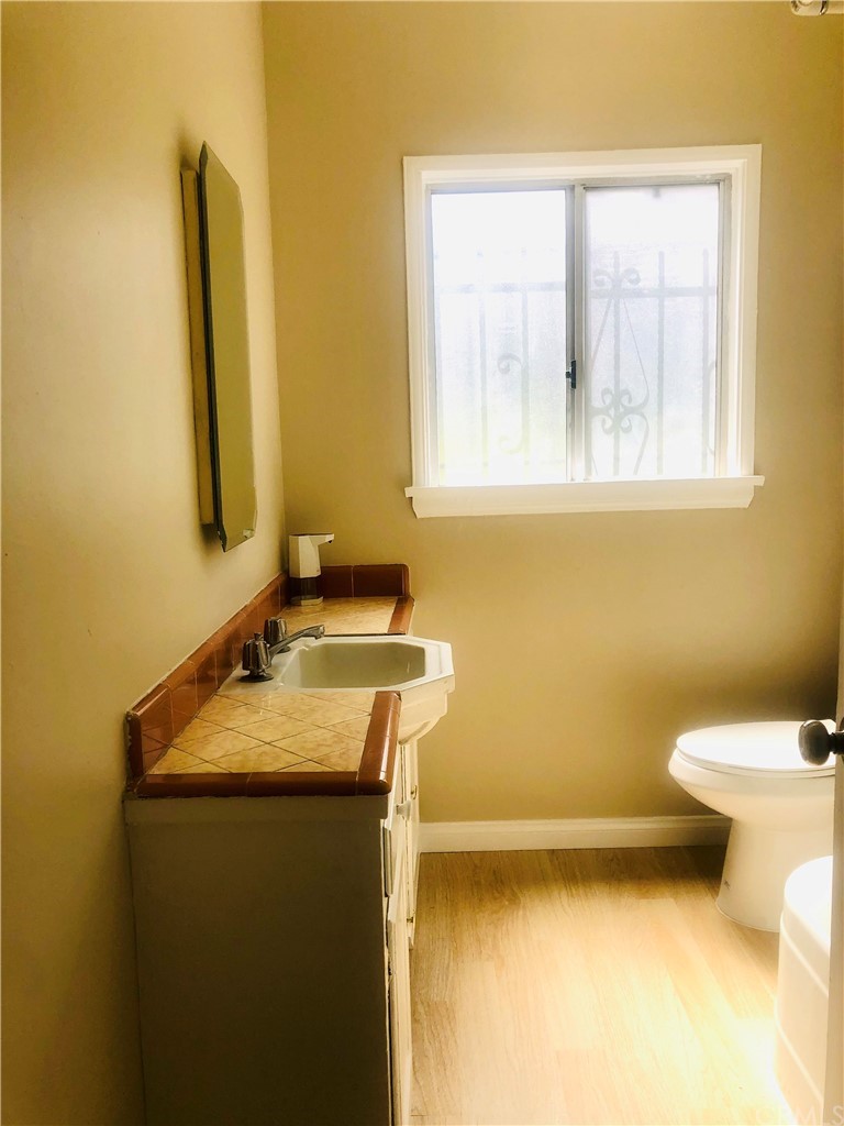 406 West Elm Street Compton, CA 90220 - Photo 10 of 16 a bathroom with a sink and a toilet